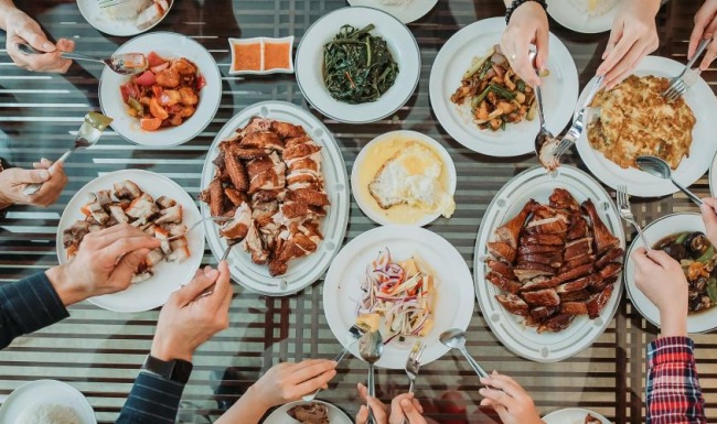 people eating food from plates