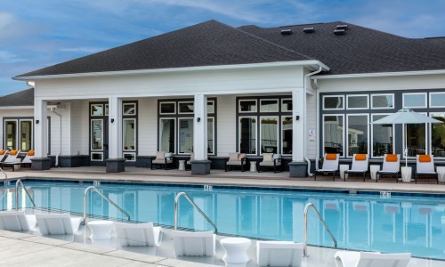 Resort-style swimming pool with lounge seating